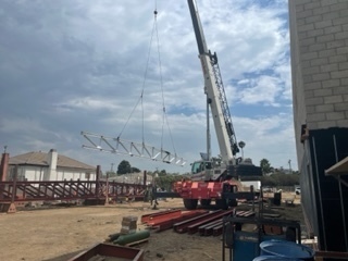 Steel beam being lifted into place.